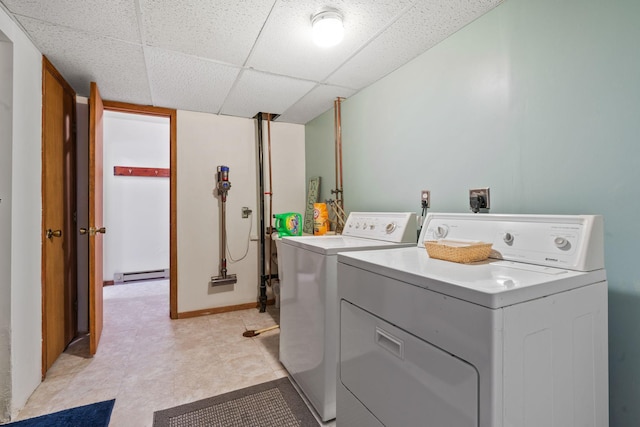 washroom featuring laundry area, washer and dryer, baseboards, and a baseboard radiator