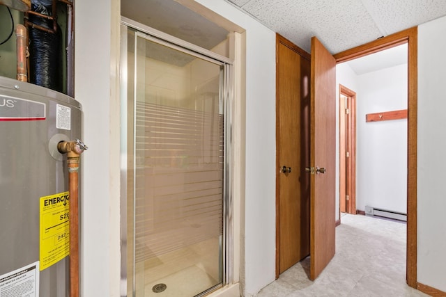 bathroom featuring a stall shower, water heater, a drop ceiling, and a baseboard radiator