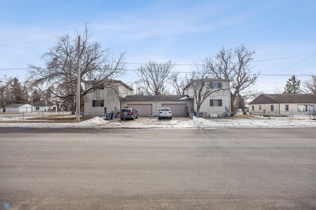 view of front of property with a garage and fence