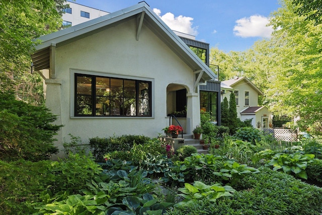 rear view of house with stucco siding