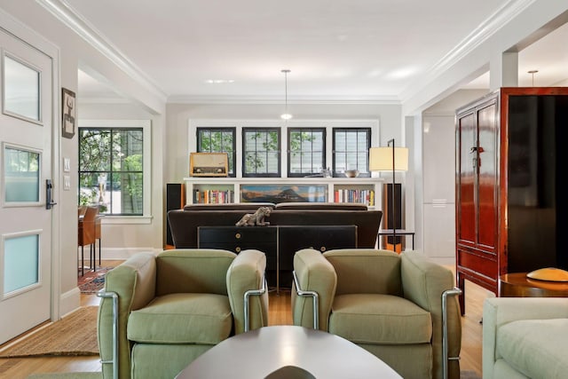 sitting room featuring baseboards, wood finished floors, and crown molding