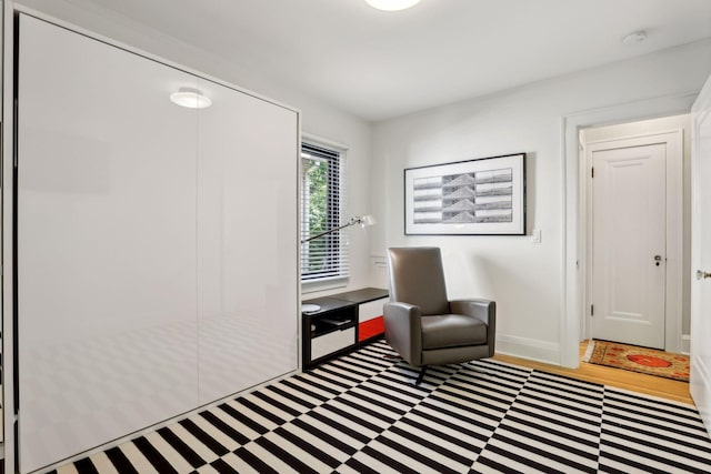 living area featuring baseboards