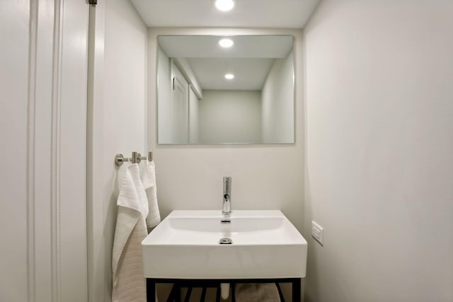 bathroom with recessed lighting and a sink