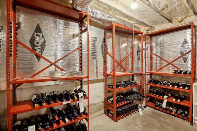 wine cellar with concrete floors and concrete block wall