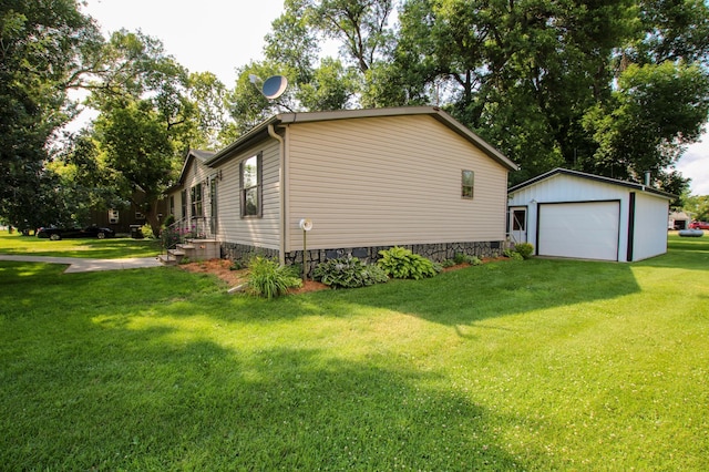 view of home's exterior featuring an outbuilding, driveway, a lawn, and a detached garage