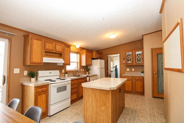 kitchen with white appliances, light countertops, a sink, and under cabinet range hood