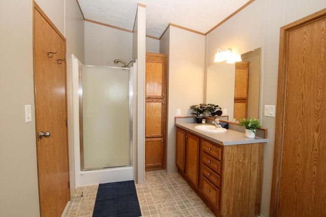 full bath with ornamental molding, a stall shower, and vanity