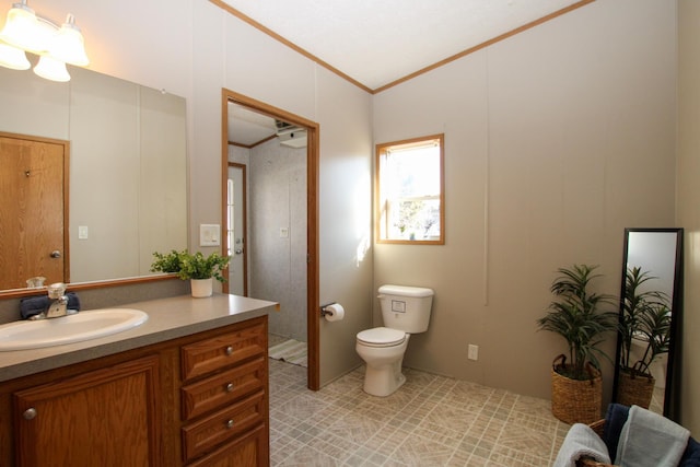 bathroom with ornamental molding, vanity, and toilet