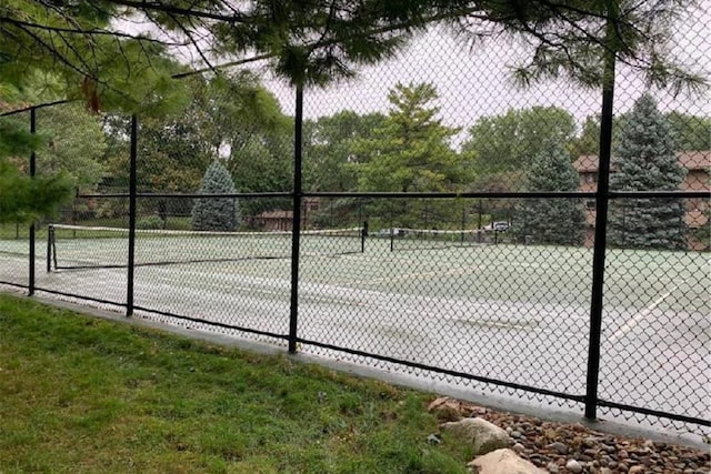 view of sport court featuring fence