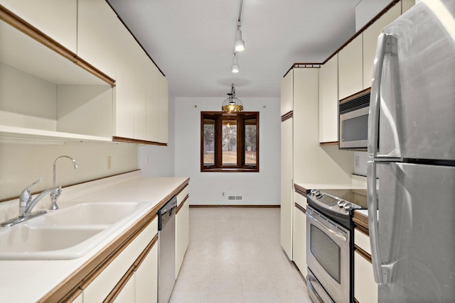 kitchen featuring visible vents, a sink, white cabinetry, appliances with stainless steel finishes, and light countertops