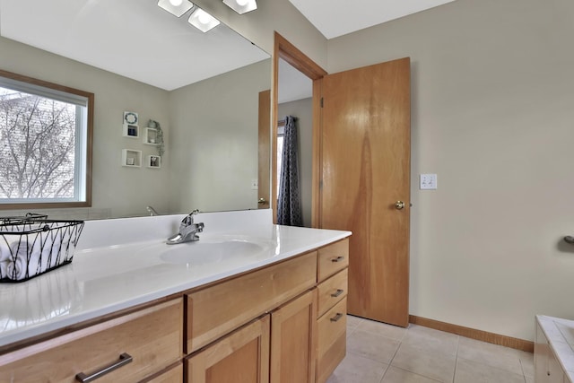 bathroom with tile patterned flooring, vanity, and baseboards