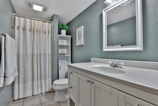 full bathroom featuring visible vents, toilet, tile patterned floors, a textured ceiling, and vanity