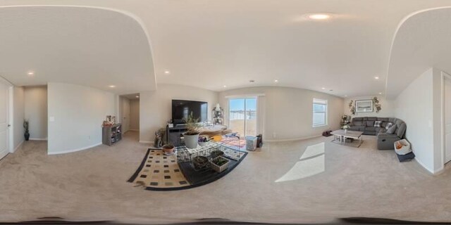 carpeted living room with recessed lighting, baseboards, arched walkways, and vaulted ceiling