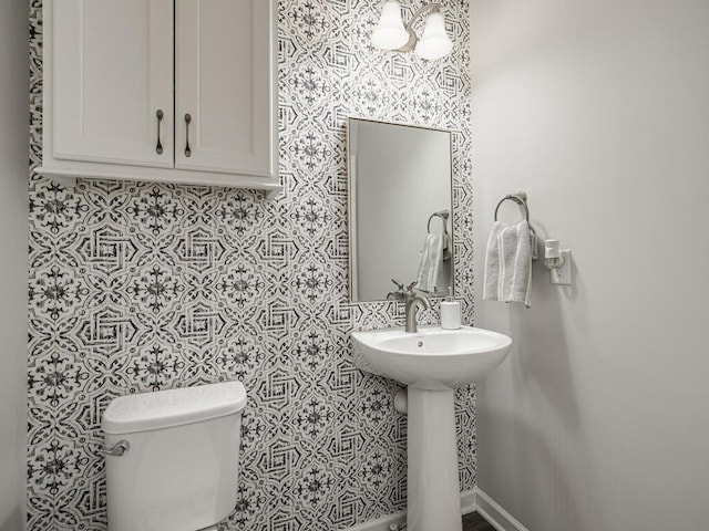 half bath featuring a sink and toilet