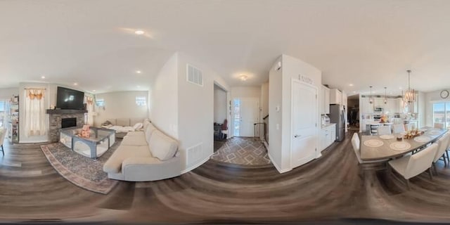 living area with visible vents, recessed lighting, a fireplace, and dark wood-style flooring