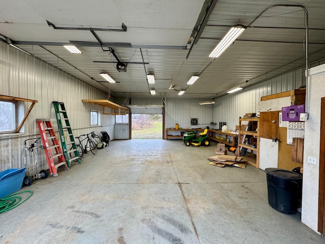 garage with metal wall and a garage door opener