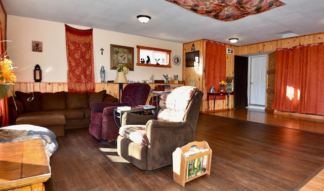 living area featuring wood-type flooring and wooden walls