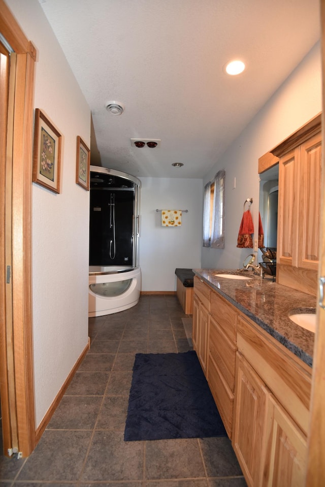 full bathroom with double vanity, baseboards, visible vents, a shower with door, and a bath