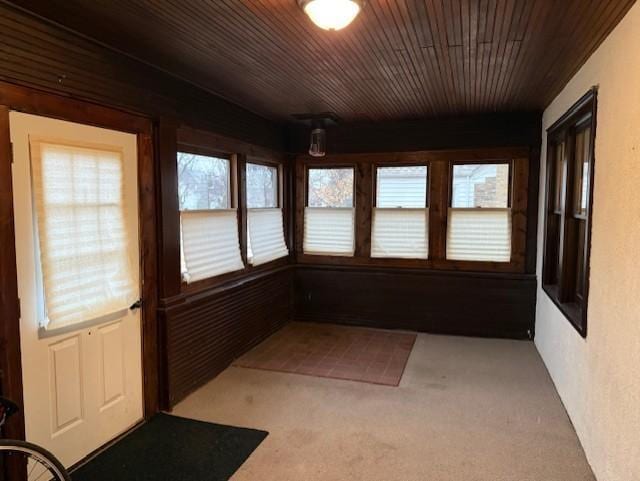 unfurnished sunroom with wood ceiling