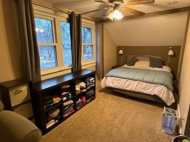 bedroom featuring a ceiling fan, carpet flooring, and vaulted ceiling