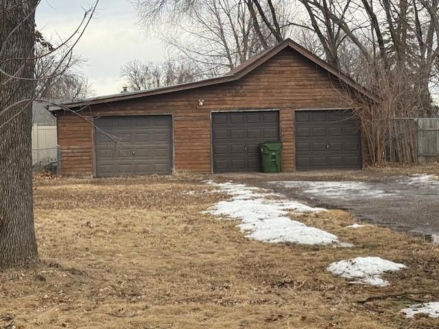 detached garage featuring fence