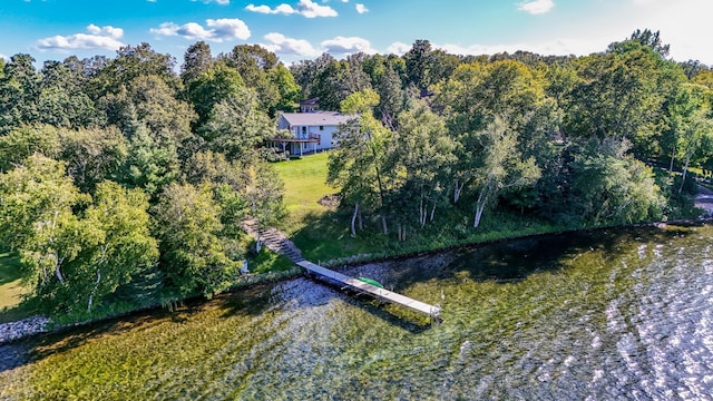 drone / aerial view featuring a forest view and a water view