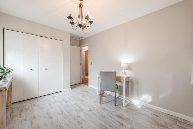 unfurnished bedroom featuring a notable chandelier, wood finished floors, a closet, and baseboards