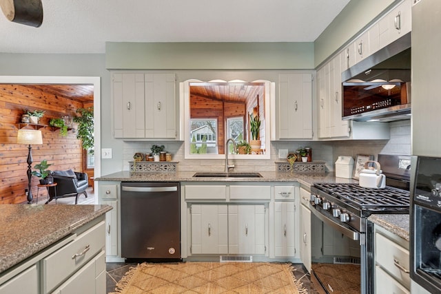 kitchen with visible vents, a sink, light stone counters, stainless steel appliances, and decorative backsplash