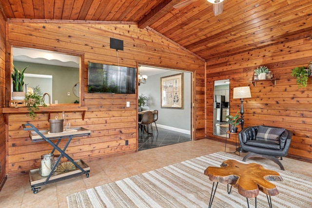 living area featuring ceiling fan with notable chandelier, wooden walls, wooden ceiling, tile patterned flooring, and lofted ceiling