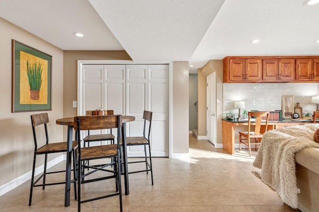 dining room featuring recessed lighting and baseboards