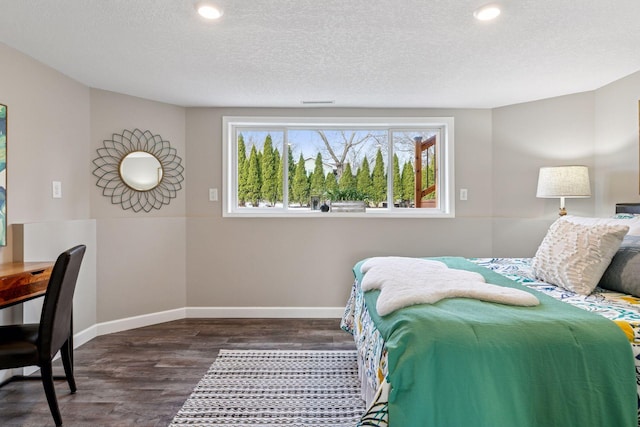 bedroom featuring recessed lighting, wood finished floors, baseboards, and a textured ceiling