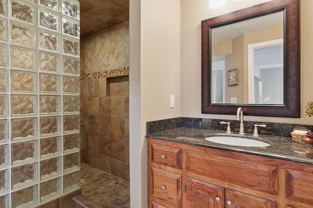 bathroom featuring vanity and a walk in shower