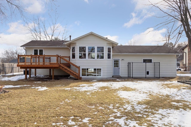 snow covered property featuring stairway, a deck, and fence