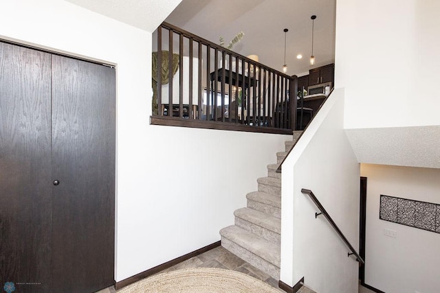 stairway featuring baseboards