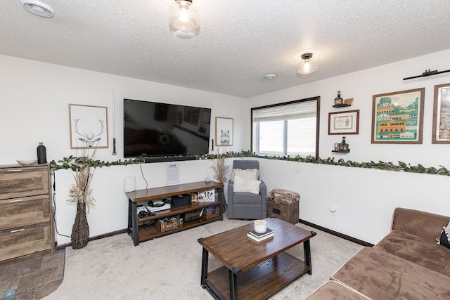 carpeted living area with baseboards, visible vents, and a textured ceiling