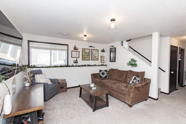 living area with light carpet, stairway, and a textured ceiling