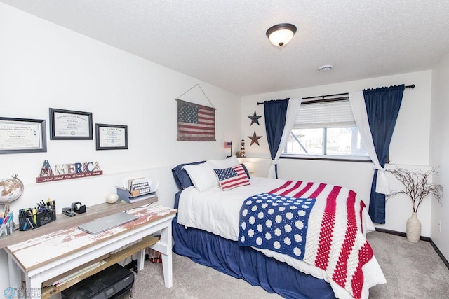 carpeted bedroom with a textured ceiling and baseboards