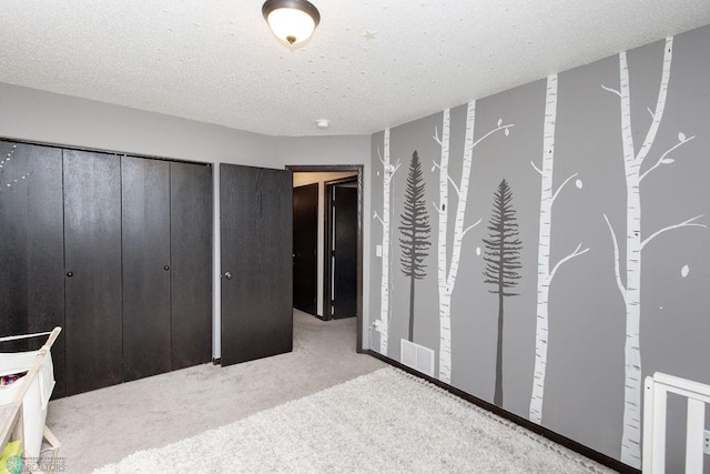 carpeted bedroom with visible vents and a textured ceiling