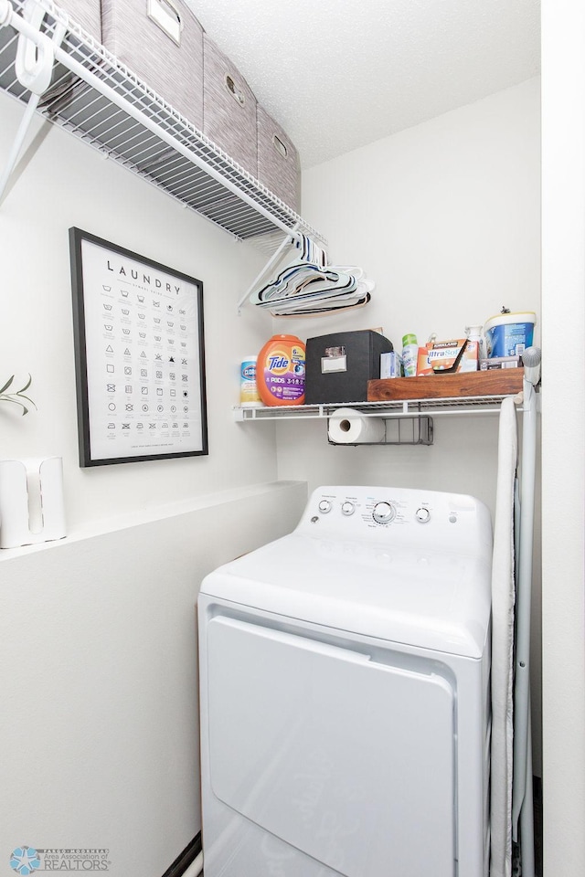 washroom with laundry area and washer / clothes dryer