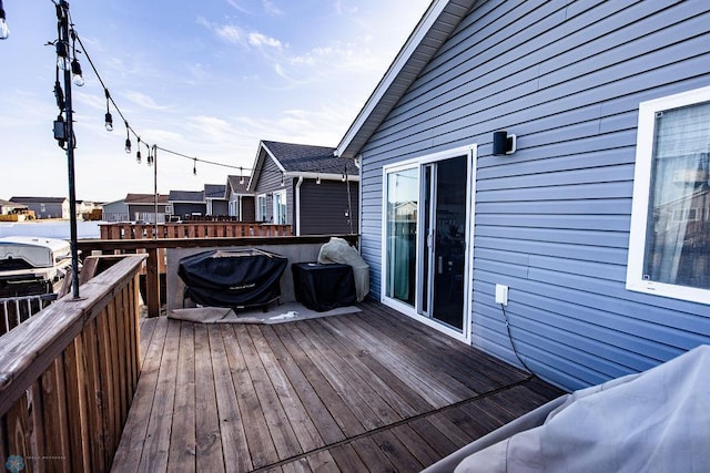 wooden terrace with a grill