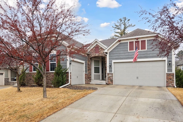 craftsman-style house with a garage, a shingled roof, driveway, stone siding, and a front lawn