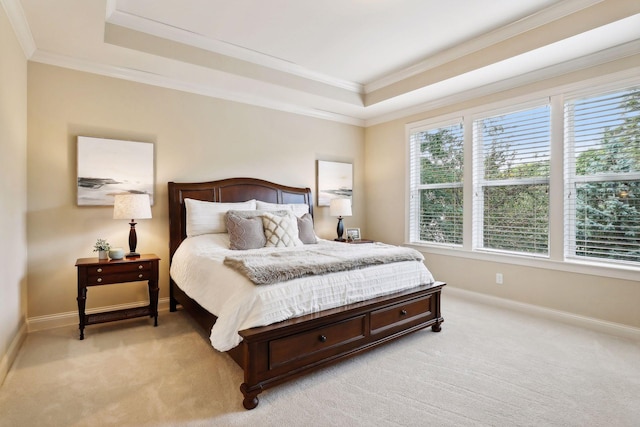 bedroom with light carpet, baseboards, a tray ceiling, and crown molding