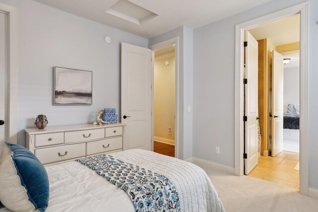 bedroom featuring carpet, attic access, and baseboards