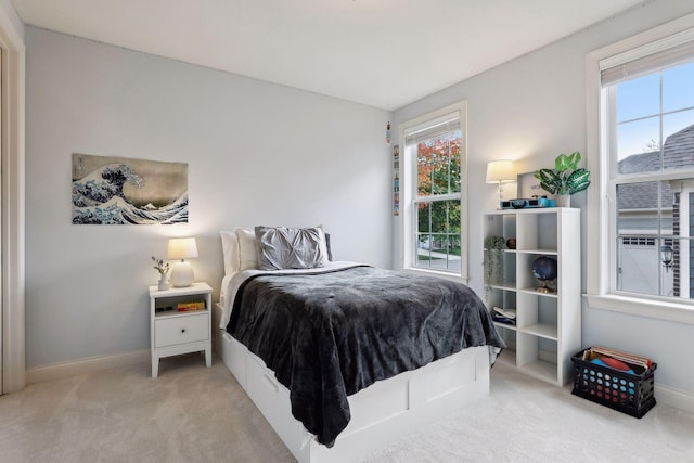 carpeted bedroom featuring baseboards