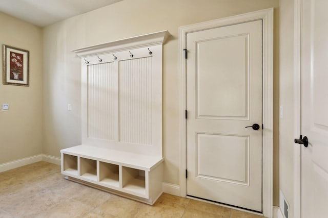 mudroom with light tile patterned floors and baseboards