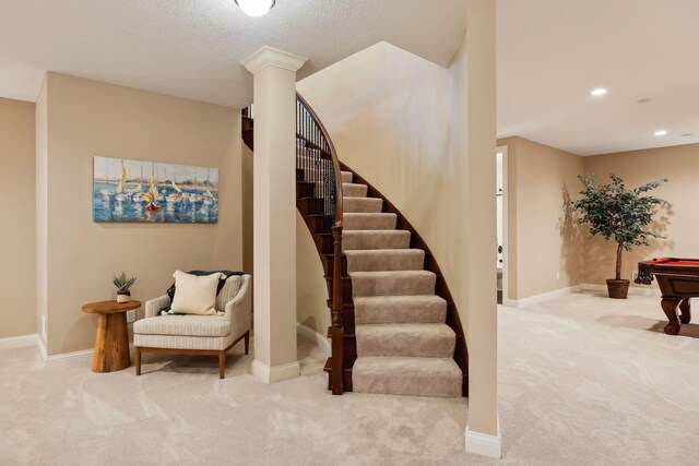 stairs featuring carpet, ornate columns, baseboards, and recessed lighting