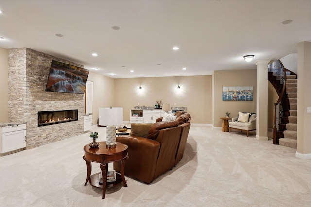 living area with light carpet, stairs, a fireplace, and recessed lighting