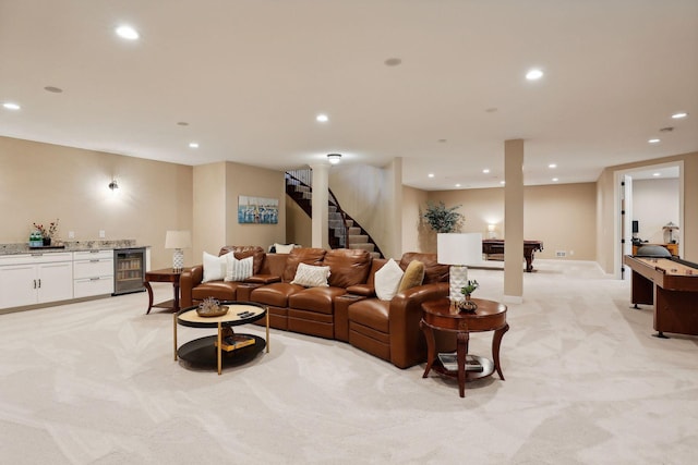 living room with light carpet, a bar, wine cooler, and recessed lighting