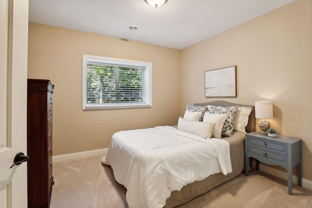 carpeted bedroom featuring baseboards