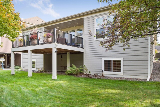 rear view of property with central AC and a lawn